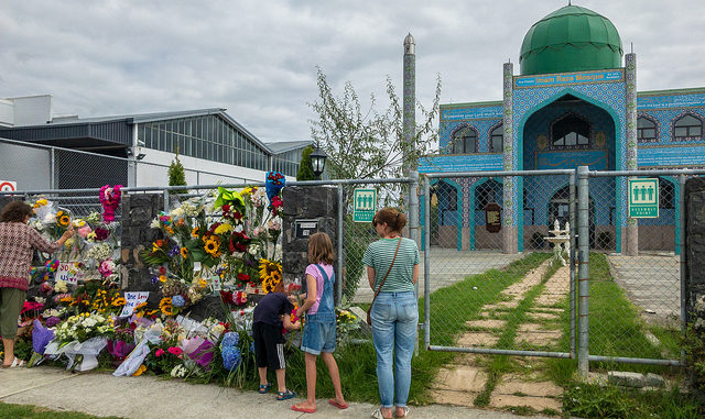 Neighbours laying flowers at Imam Reza Mosque, the day after the massacre at Al Noor Mosque in Christcurch, New Zealand, CC. By Nick.