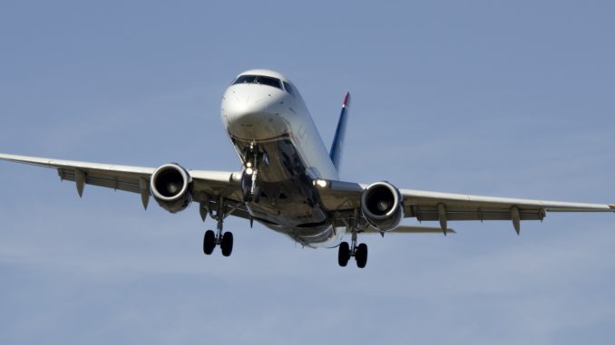 An aeroplane in the air readying for landing