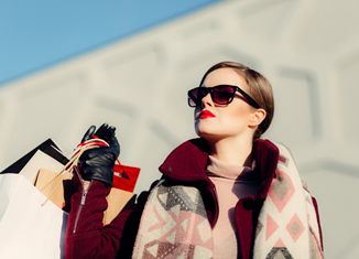 A fashionable woman holding paper bags