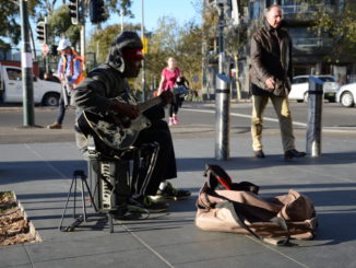 An indigenous man busking outside Redfern station