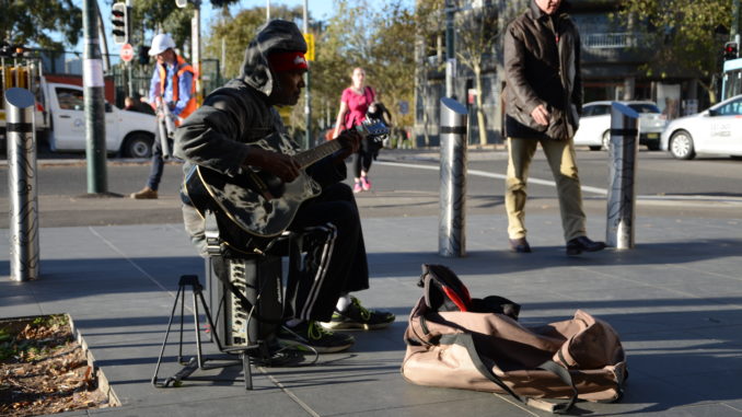 An indigenous man busking outside Redfern station