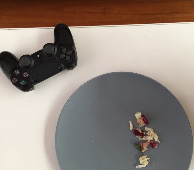 Playstation controller and plate with leftover lunch