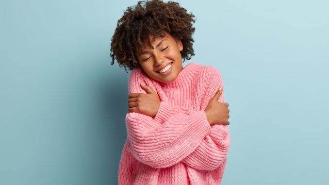 Girl hugging herself