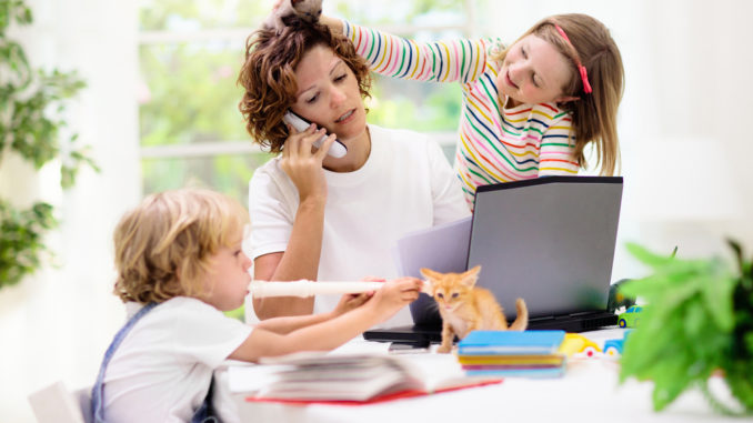 Mother working from home with kids