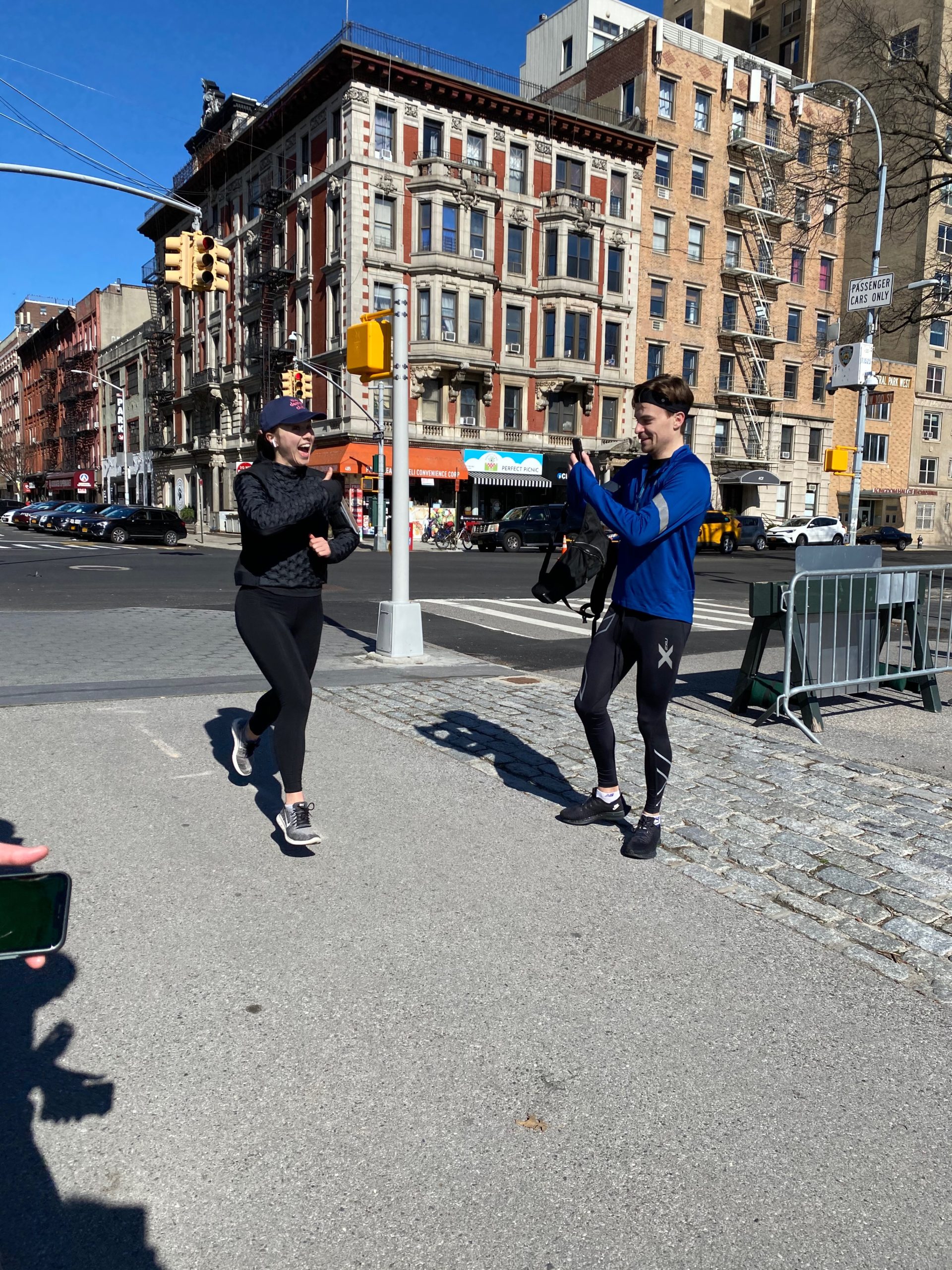 Woman running with man taking photo