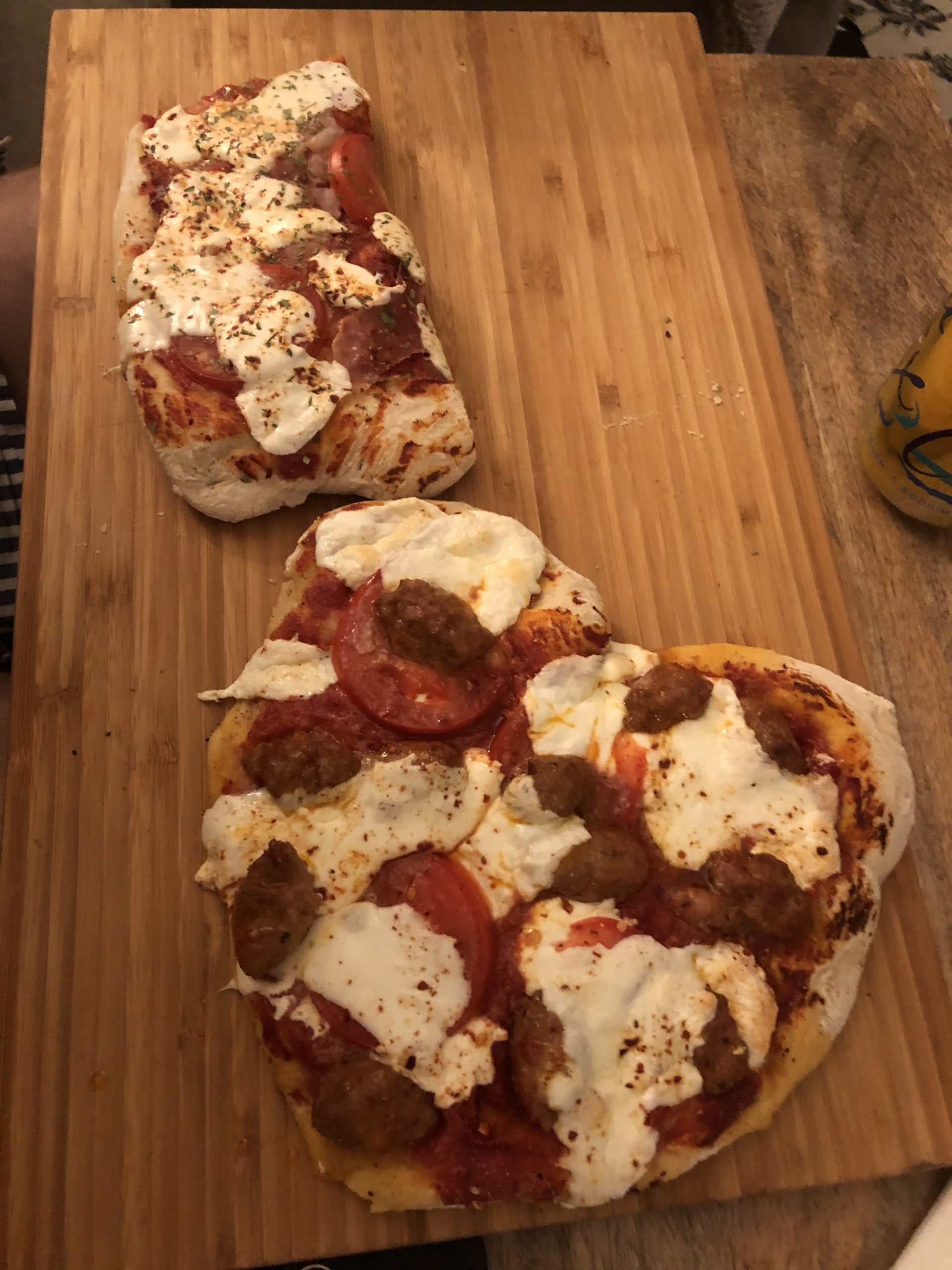 Heart shaped pizza on wooden board