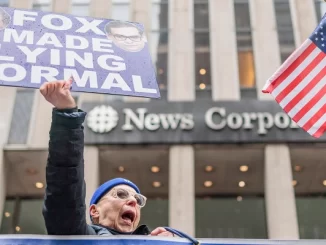 People protest outside News Corporation headquarters in New York