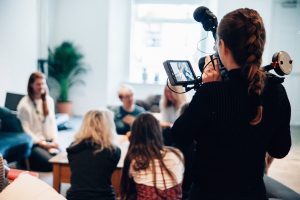 Photo shows a mobile journalist using smartphone to record video