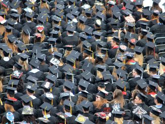 A see of college graduates at the commencement ceremony.