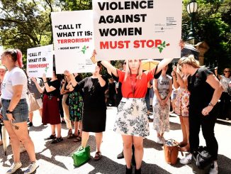 Protesters demand action against domestic violence at a rally in Brisbane on Friday. Picture: AAP