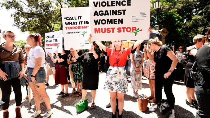 Protesters demand action against domestic violence at a rally in Brisbane on Friday. Picture: AAP