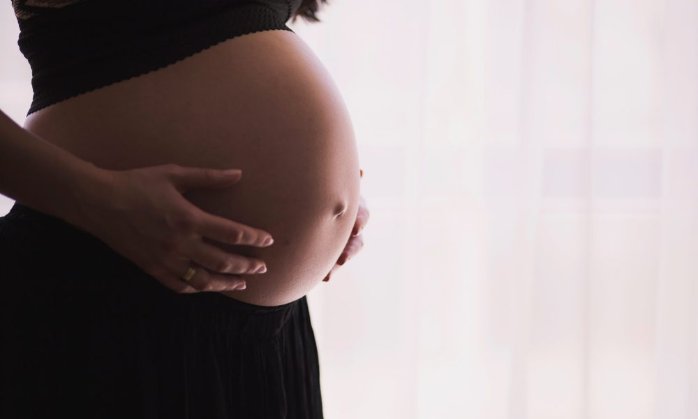 pregnant woman holding her belly