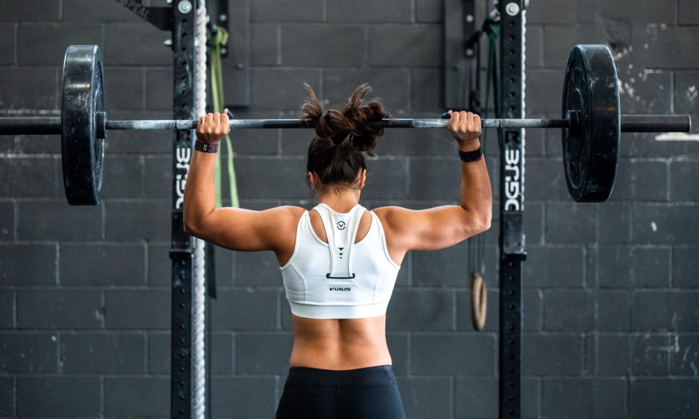 woman lifting weights at the gym