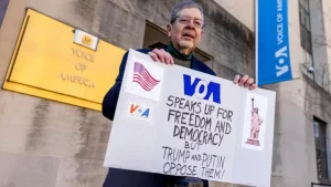 Employees' son protests outside VOA