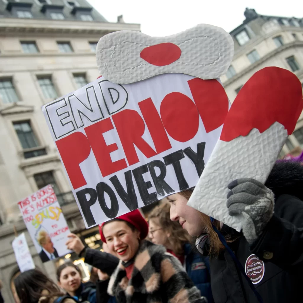 People marched holding signs that read END PERIOD POVERTY