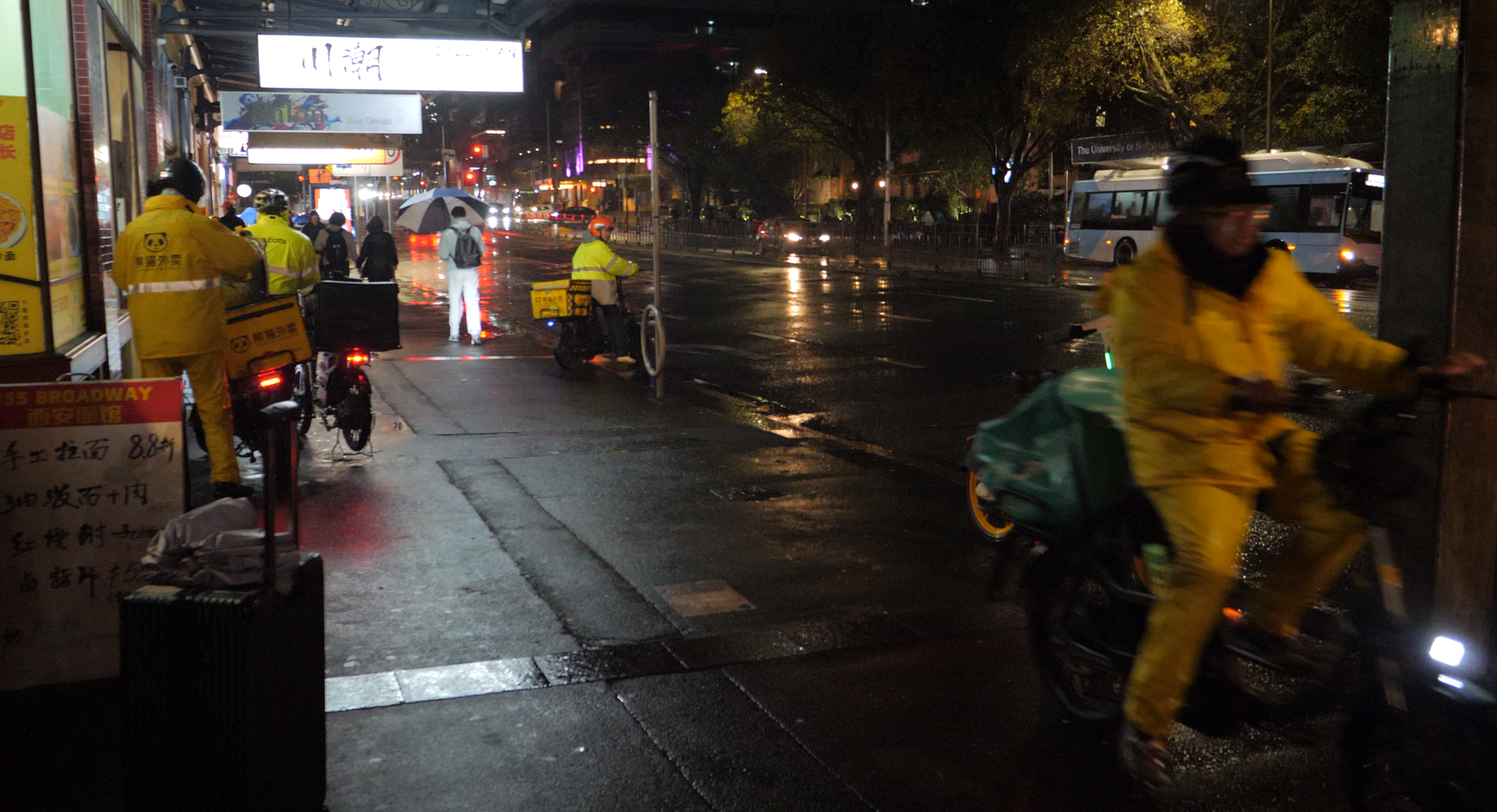 Delivery riders come and go outside a Chinese restaurant in Sydney. // Photo by Lyn Zhan
