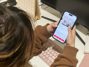 Yolanda Tan browsing rental listings on her phone