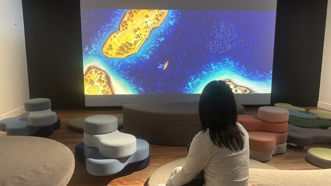 Nan watching the animation Barani – A Sydney Harbour Story (Image Credit: Yi Yang)