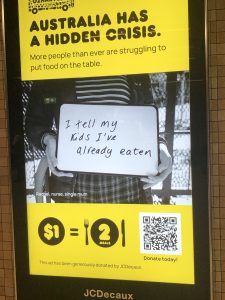 An Oz Harvest ad at a train station