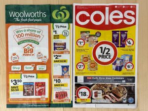 Promotional catalogue pages from Woolworths and Coles showing discounted grocery items for the week.